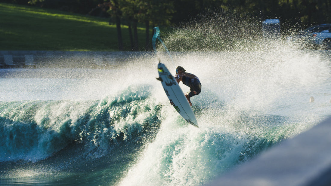 Man jumping up out of big wave on surfboard