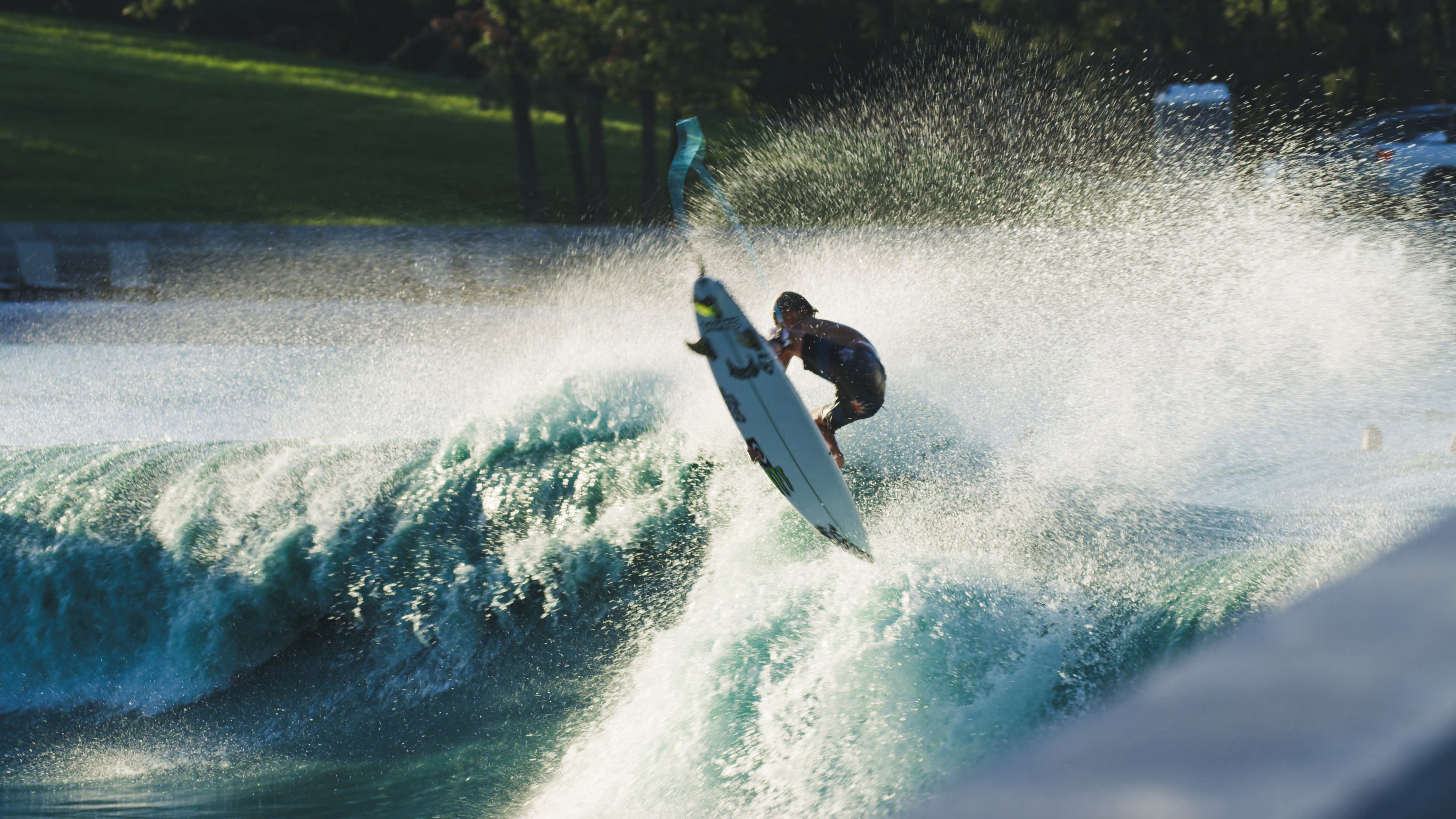 Man jumping up out of big wave on surfboard