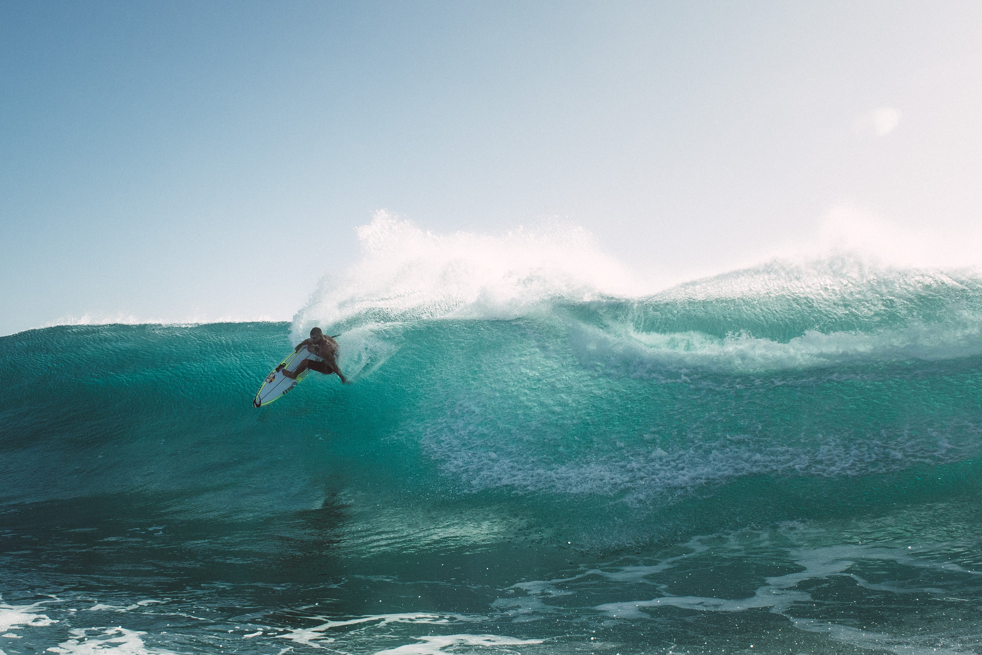 Man surfing into big turquoise wave