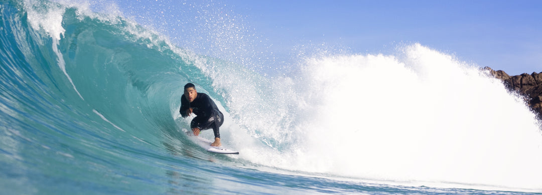Man surfing barrel of wave