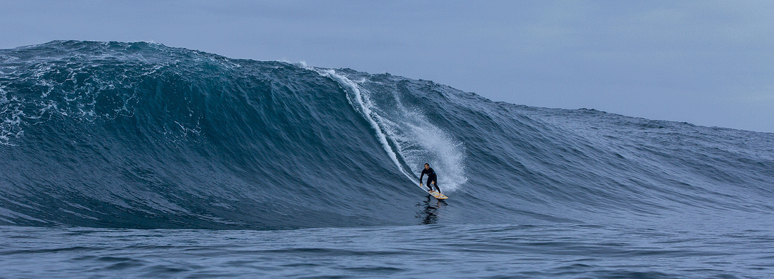 Gif of man catching wave