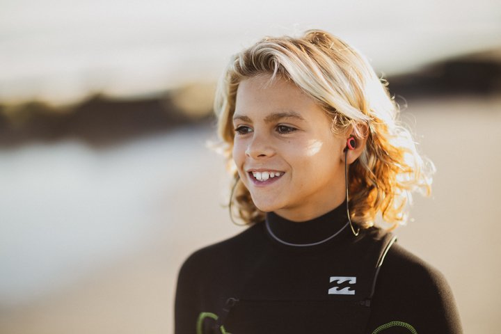 young blonde boy wearing surf ear protectors
