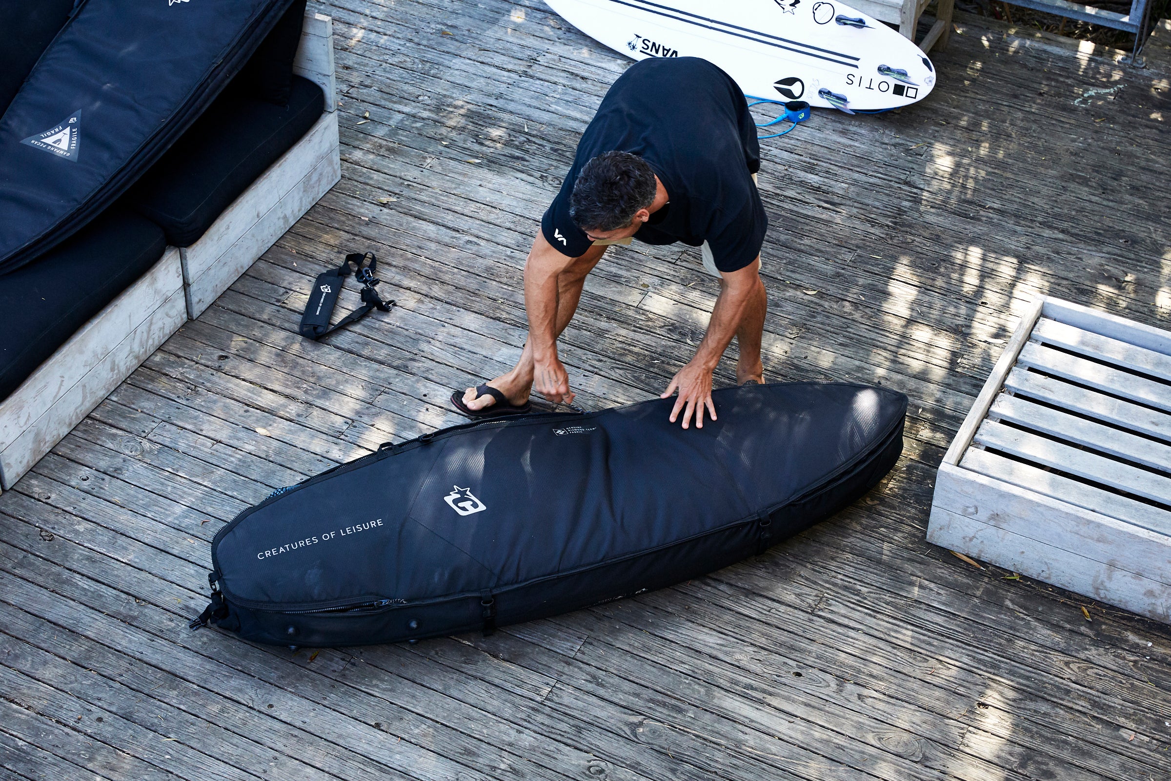 Man packing surf bag
