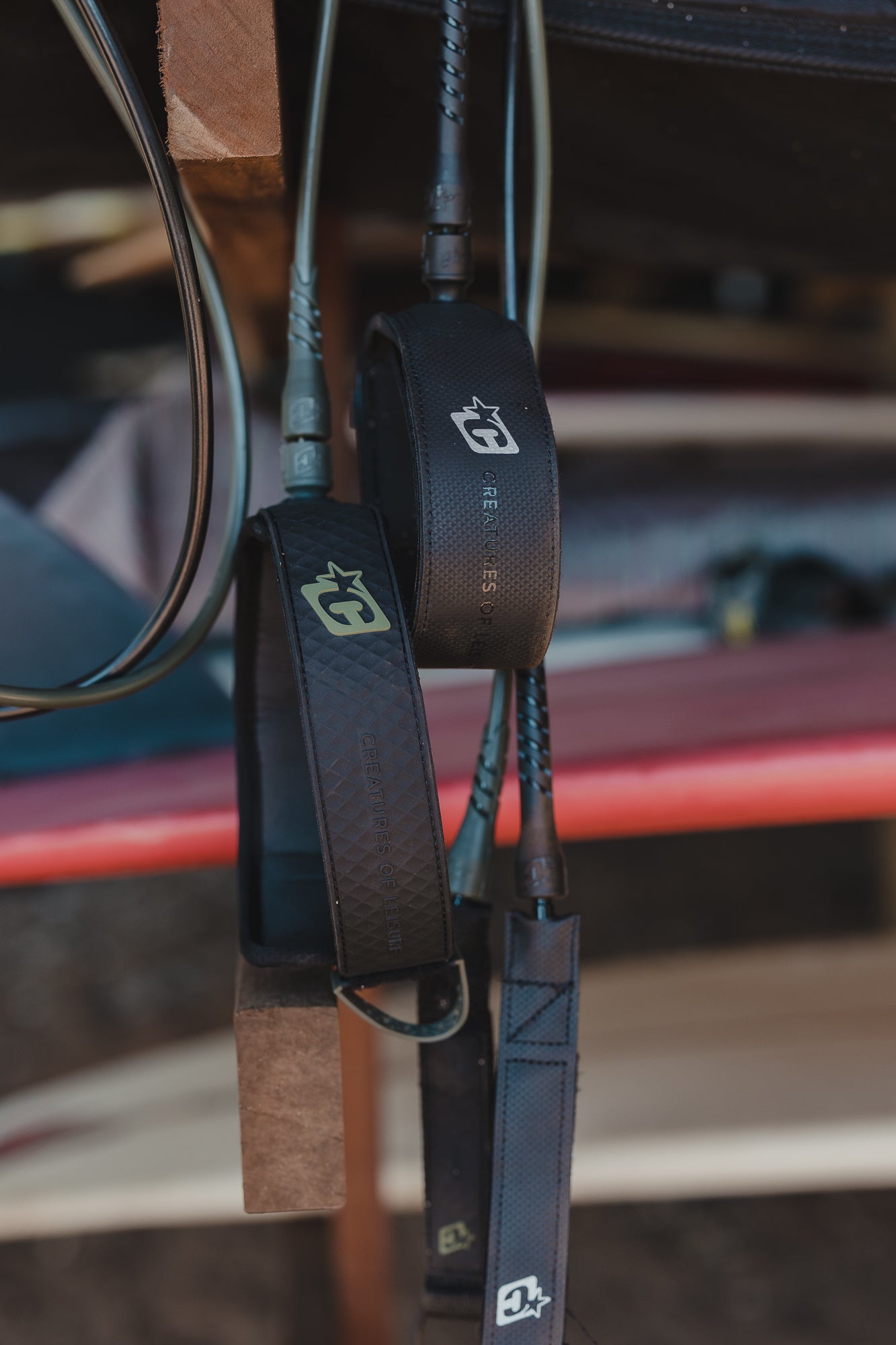 leashes hanging in garage with surfboard