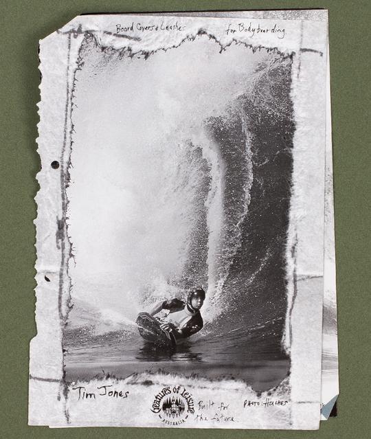 Surfer on stomach in black and white pic